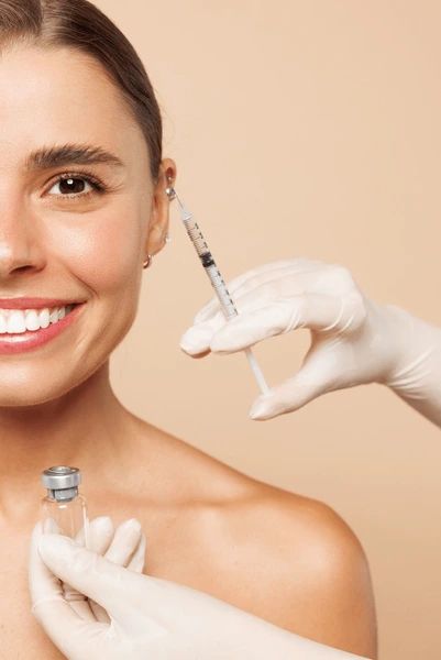 Hands applying professional skincare in a clinical setting
